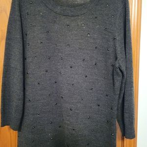 Black pullover sweater with sparkly grommets